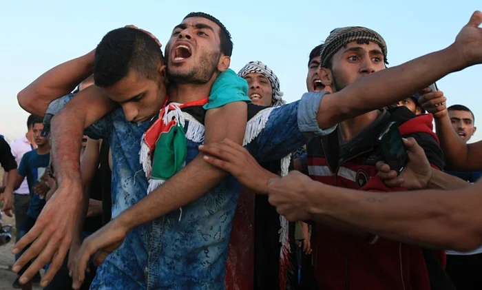 Palestinians carry a wounded protester, during clashes near the Gaza border fence last week. Photograph: Majdi Fathi/NurPhoto/Corbis