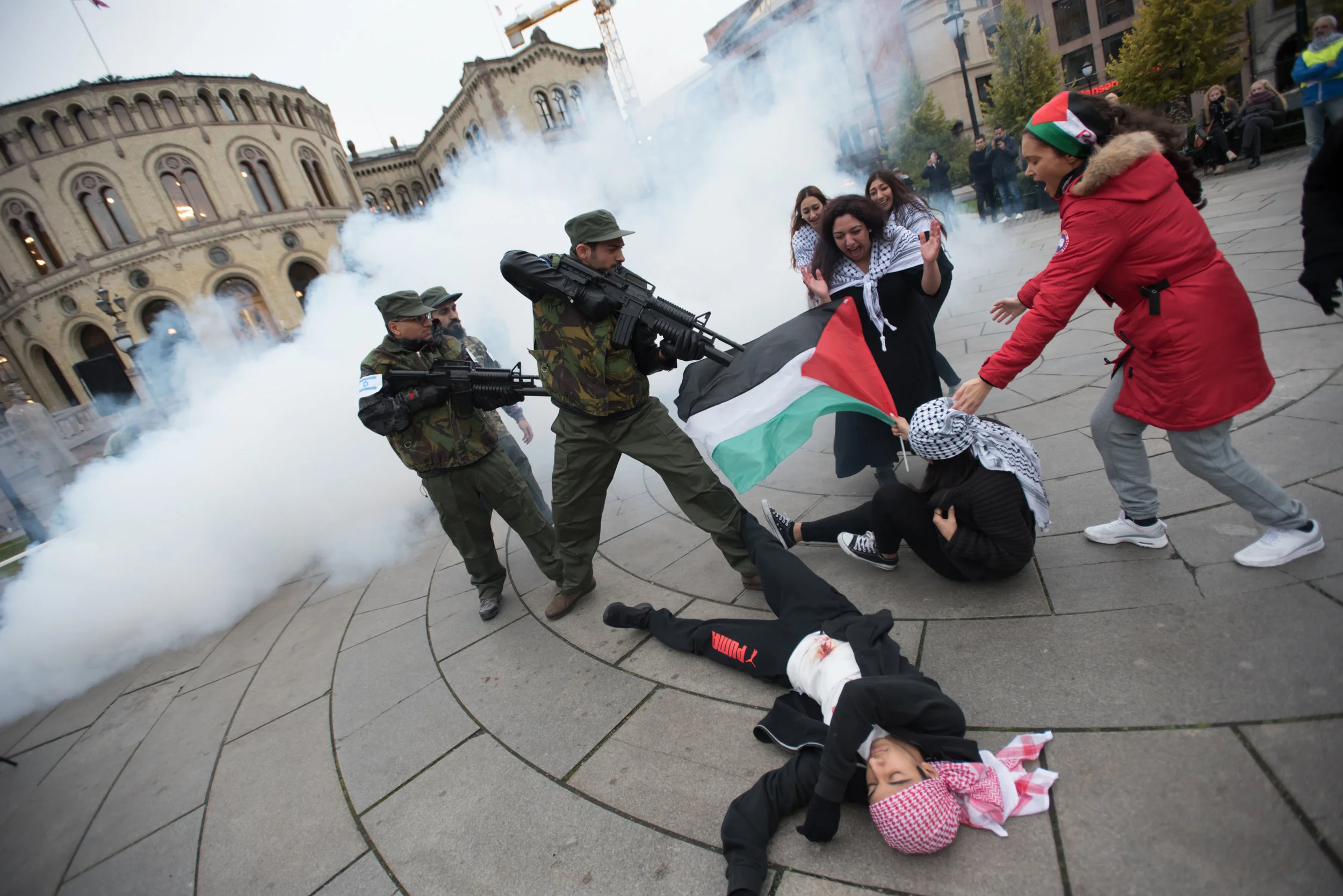 Street theatre by activists in Oslo highlighting the impact of the Norwegan arms trade with Israel